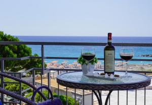 a table with a bottle of wine and two glasses at Sole Mare in Ventimiglia