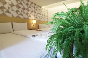 A bed or beds in a room at Dream 12 Hotel