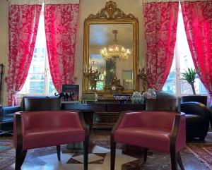 
a living room filled with furniture and decorations at Hotel Verdi Boutique Hotel in Parma
