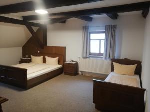 a bedroom with two beds and a window at Gaststätte Liebl in Wiesent