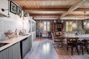 a kitchen with a wooden floor and a table at Domek nad Galerią in Lanckorona