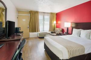 a hotel room with a bed and a television at Econo Lodge Marion I-81 in Marion