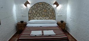 A bed or beds in a room at Cuevas Lourdes