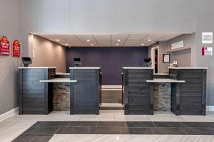 a hair salon with two sinks and a mirror at Clarion Hotel Conference Center - North in Lexington