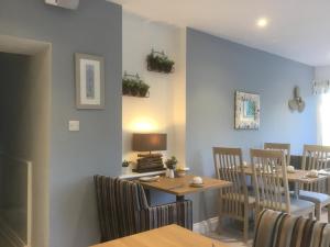 a dining room with chairs and a table with a lamp at Cairn House in Ilfracombe