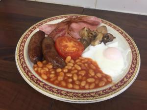 a plate of breakfast food with beans and eggs at Cairn House in Ilfracombe