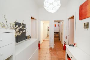 a living room with a hallway with a vase of flowers at Be First in Rome