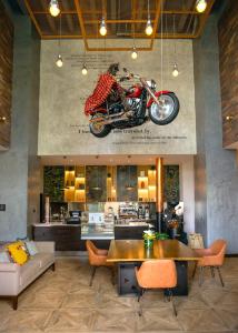 a living room with a table and a motorcycle on the wall at The Social House Nairobi, a Preferred Lifestyle Hotel in Nairobi