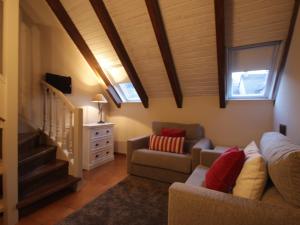 a living room with a couch and a chair at Hotel Ostau d'Òc in Vielha