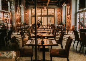 a row of tables and chairs in a restaurant at Korona Hotel Wroclaw Market Square in Wrocław