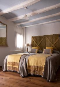 a bedroom with two beds and a window at Ca la Casilda in Prades