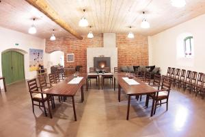 a large room with tables and chairs and a fireplace at Eistvere Manor Accommodation in Eistvere