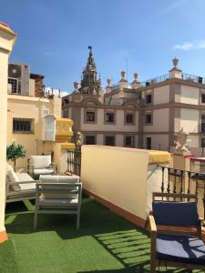 a view of a balcony with chairs and a building at Constitución Terraza in Seville