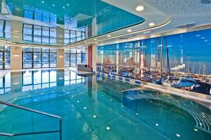 a large swimming pool in a building with a cruise ship at Hotel Mikołajki Leisure & SPA - Destigo Hotels in Mikołajki