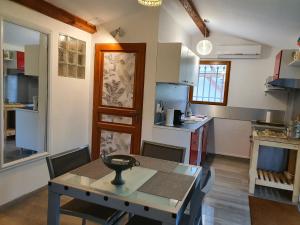 a kitchen with a table and a dining room at Cottage Perla Vita in Le Cannet