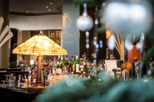 a bar with a lot of bottles of alcohol at Jehan De Beauce - Teritoria in Chartres