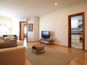 a living room with a couch and a tv at D22145 reina elisenda in Sant Feliu de Guíxols
