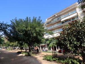 a large building with trees in front of it at D22145 reina elisenda in Sant Feliu de Guíxols