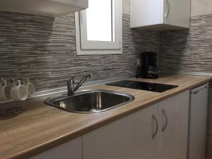 a kitchen with a sink and a counter top at Rio Sol - Oasis de Privacidad in Costa Calma
