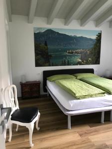 a bedroom with a bed and a painting on the wall at Villa Cà bianca in Torri del Benaco +29 photos