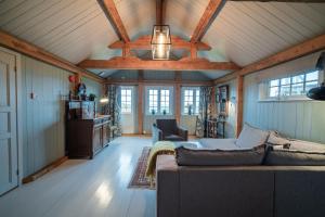 a living room with a couch and a ceiling at Håholmen - by Classic Norway Hotels in Karvåg