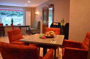 a dining room with a table with a bowl of fruit on it at Sonnenhof-Willingen in Willingen