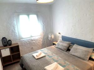 a bedroom with a bed with two towels on it at Tartanas 144 playa del inglés, jumbo in Playa del Ingles +18 photos