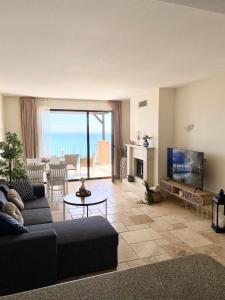 a living room with a couch and a television at Sea Bay View Apartment in Topola