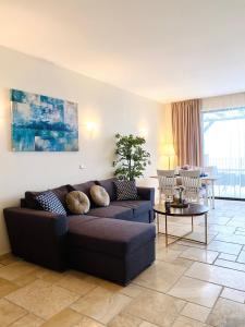 a living room with a couch and a table at Sea Bay View Apartment in Topola