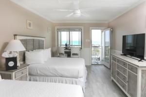 a hotel room with two beds and a flat screen tv at Marquis De Lafayette in Cape May