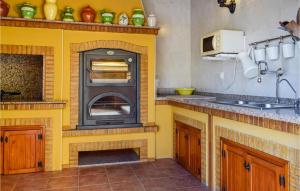 a kitchen with a yellow oven in a kitchen at Cozy Home In Orihuela in Orihuela