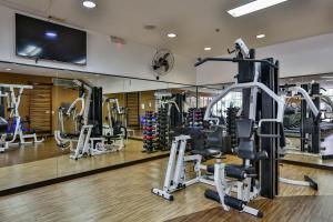 a gym with tread machines and a flat screen tv at Transamerica Prime International Plaza (Paulista) in Sao Paulo