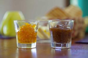 two glasses of food sitting on a wooden table at Chacra del Agua Reserva Privada in Saltos del Moconá