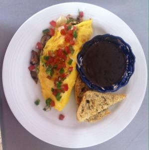 a plate of food with a omelet and a sandwich at La Catrina de Alcala in Oaxaca City