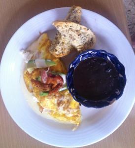 a plate of food with eggs and toast and sauce at La Catrina de Alcala in Oaxaca City