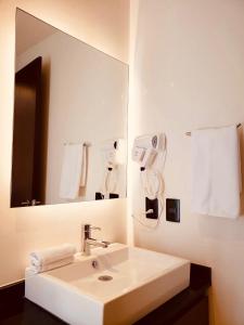 a bathroom with a white sink and a mirror at Meliora by Bunik in Playa del Carmen