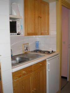 a small kitchen with a sink and a microwave at clos des gentianes in Allevard