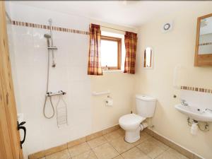 a bathroom with a toilet and a sink at Wolds View in Cornisholme