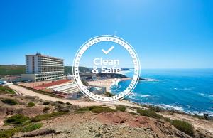 a sign for a clean and safe hotel next to the ocean at Hotel Golf Mar in Maceira