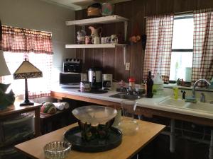 a kitchen with a sink and a counter top at Lucky 7/ Rainbow motel in Murphy