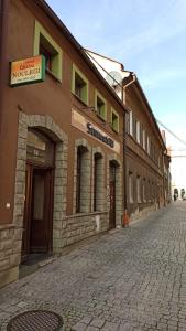 a building on the side of a cobblestone street at pokoje gościnne Grażyna in Cieszyn