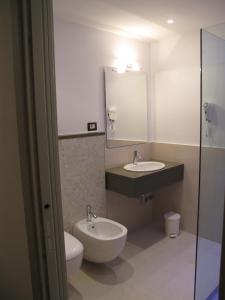a bathroom with a sink and a toilet and a mirror at Hotel Sorriso in Bellaria-Igea Marina +28 photos