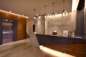 a kitchen area with a bar and a sink at Goodmore Hotel in Taipei