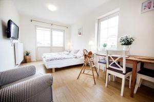 a living room with a table and a couch at Dębki Playa Apartments in Dębki +112 photos