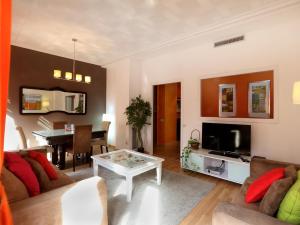 a living room with a couch and a table at Reino de Valencia Apartments in Valencia