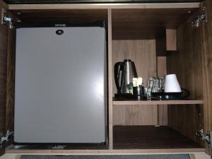 a large white door in a cabinet in a kitchen at Blue Bells Hotel in London