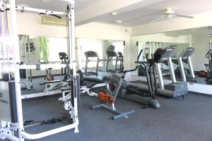 a gym with treadmills and ellipticals at Hotel Huizache in Saltillo