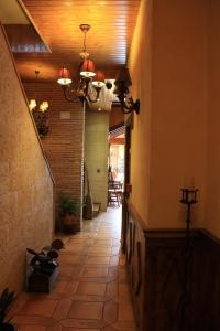 a hallway with a tile floor and a ceiling at Hotel Doña Isabel in Torrellano