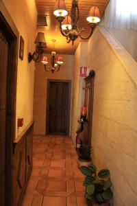 a hallway in a building with a chandelier at Hotel Doña Isabel in Torrellano