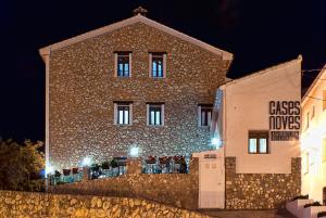a large brick building with lights in front of it at Cases Noves - Boutique Accommodation - Adults Only in Guadalest